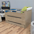 A light oak wood twin-over-one bed frame with integrated drawers and dark metal handles, styled with bedding and pillows in a bedroom setting.